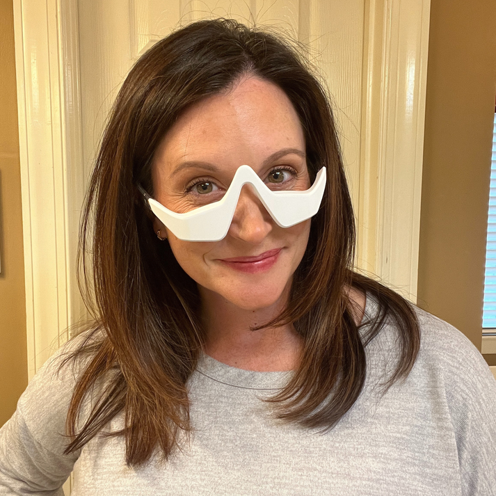 customer using Solara Glow red light mask at home