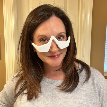 customer using Solara Glow red light mask at home